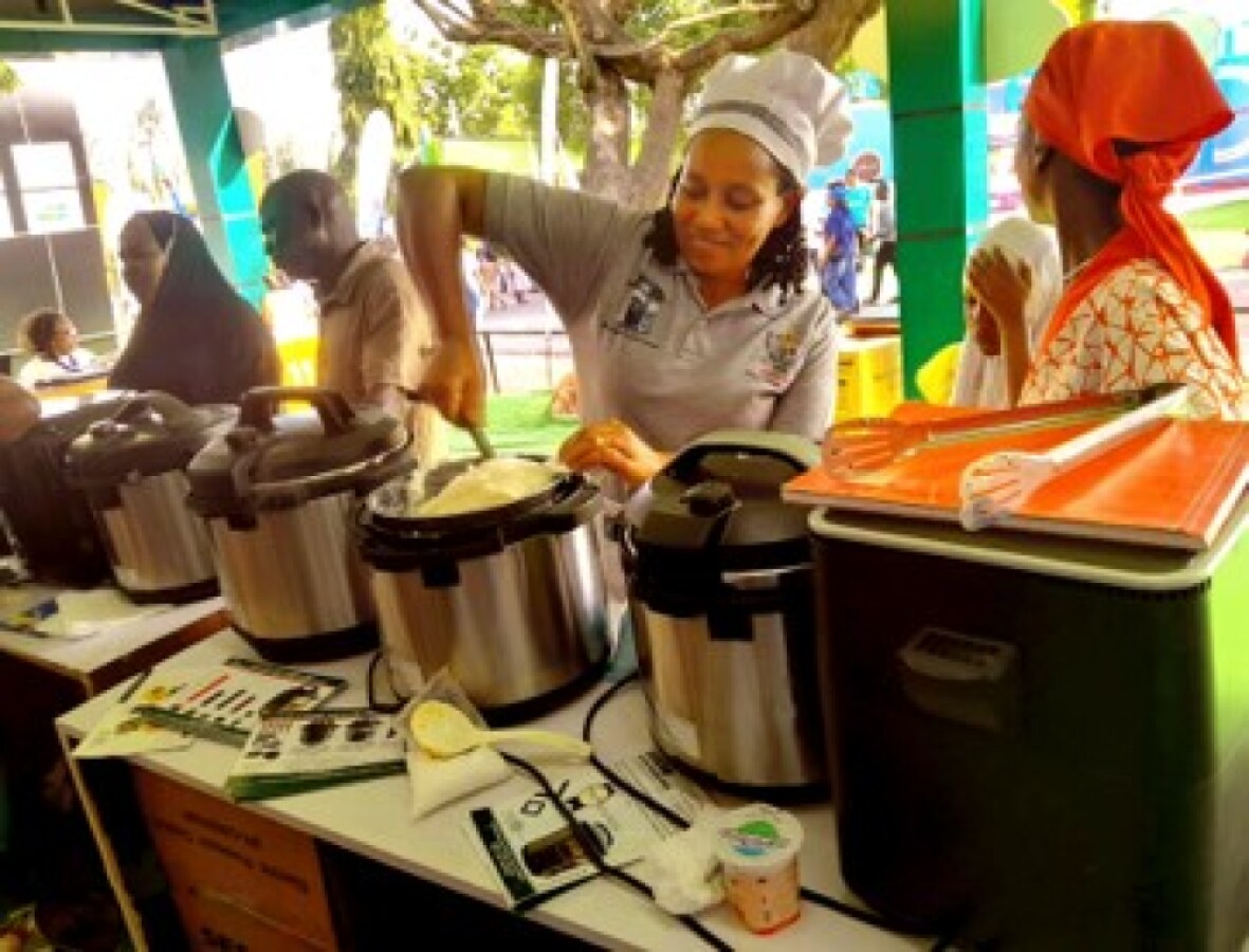 Demonstration of how to cook ugali in the EPC to customers at the TANESCO pavilion